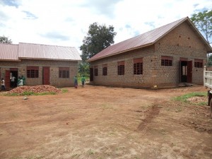 Mpunge school with windows and roof. Eager students check out the building!