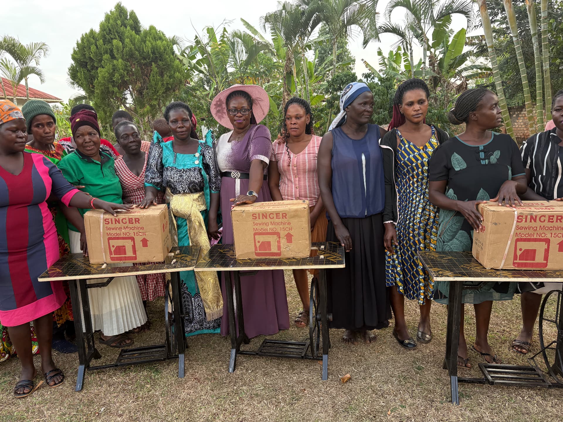 Community members receiving sewing machines